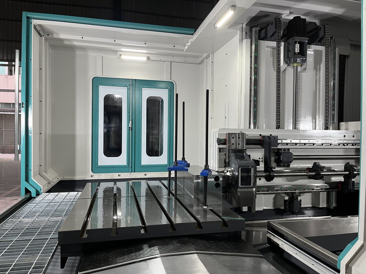 Drilling spindle and workholding table inside a machine enclosure, an illustrative workshop image